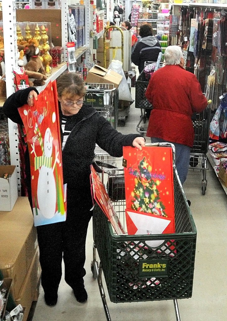 Dottie Currier, of Winslow, fills her cart with gifts packaging while shopping at Mardens Surplus and Salvage on Kennedy Memorial Drive in Waterville on Black Friday. Currier finished her shopping for her granddaughter and is focusing on finding gifts for her girlfriends for the remainder of the afternoon.