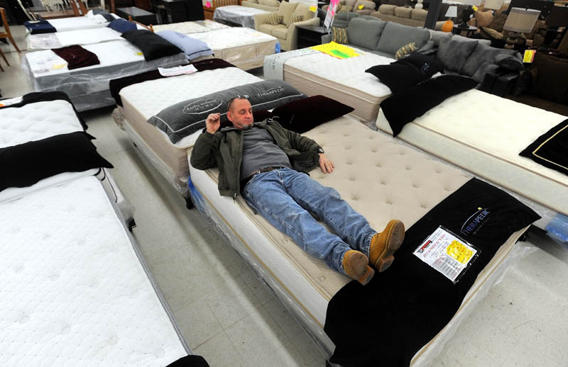 Chester Hanscom, of Fairfield, tests a mattress while shopping at Mardens Surplus and Salvage on Kennedy Memorial Drive in Waterville on Black Friday.