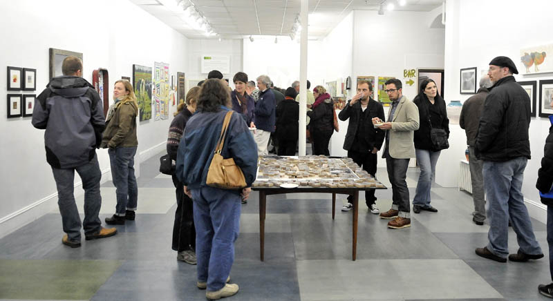 Art lovers gathered at Common Street Arts in Waterville for the opening of a new exhibit, featuring a collection of art inspired by local farms over the last growing season, on Saturday.