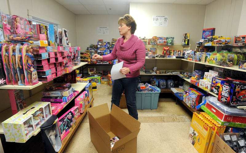 Christen Sawyer, the Christmas program director at Maine Children's Home for Little Wanderers in Waterville, prepares Christmas gift boxes for children in need in the central Maine region.