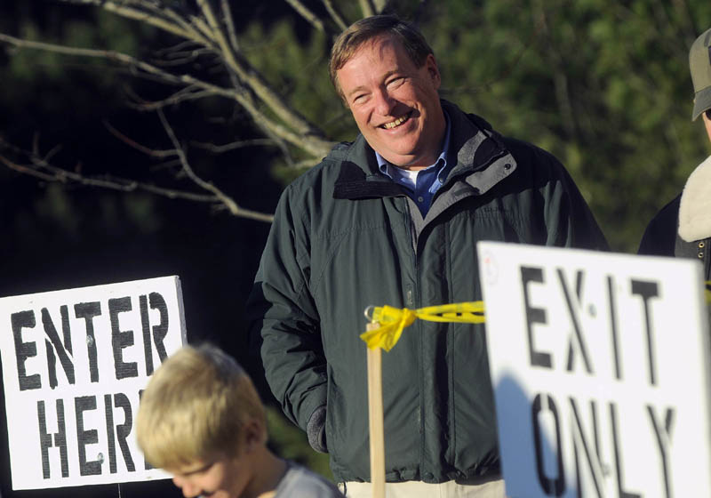 Kevin Raye greets voters at the polls at the Hampden Municipal Building on Tuesday.