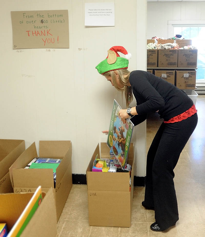Kasie Flowers, of the Waterville Housing Authority, packs gift boxes to be distributed to disadvantaged children in the area for the holidays, at the Maine Children's Home for Little Wanderers in Waterville, on Thursday.