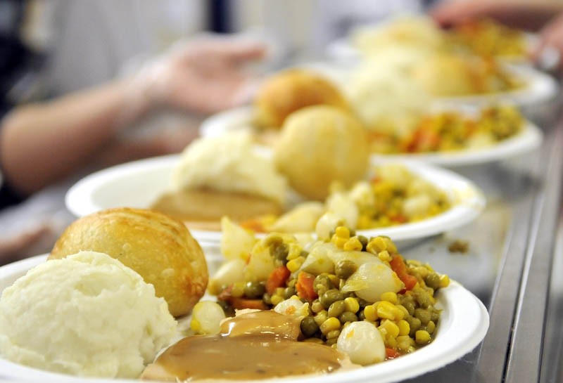 Plates of turkey, mixed vegetables, mashed potatoes and gravy wait to be served at the 23rd annual community Thanksgiving Day dinner at Messalonskee High School in Oakland, on Thursday. Over 900 people were served at the school's cafeteria and via delivered meals.