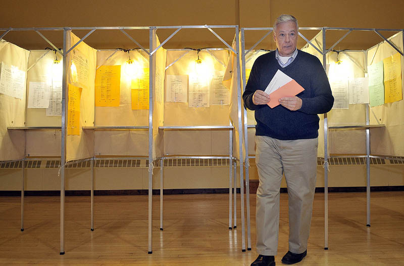 Staff photo by Michael G. Seamans Mike Michaud leaves the voting booth with his ballot at the East Millinocket Town Hall on Tuesday evening.