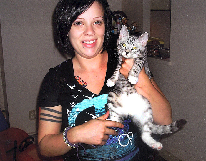 Samantha Folsom holds her kitten, Gadget, in this 2010 photo.