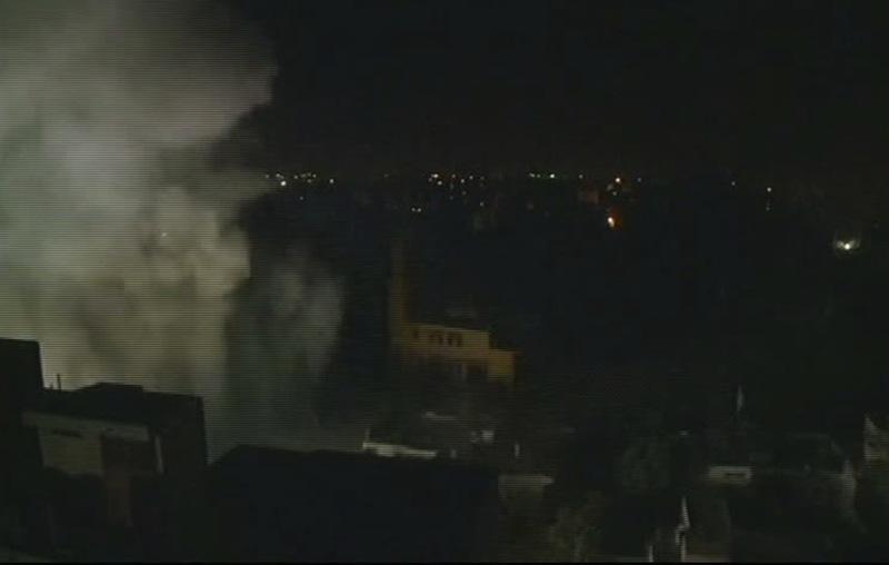 This image taken from AP video shows smoke rising from a building moments after an Israeli airstrike in Gaza City, early Wednesday, Nov. 21, 2012. Israel and the Hamas militant group edged closer to a cease-fire Tuesday to end a weeklong Israeli offensive in the Gaza Strip, but after a day of furious diplomatic efforts involving the U.S. secretary of state, U.N. chief and Egypt's president, a deal remained elusive and fighting raged on both sides of the border. (AP Photo/AP Video)