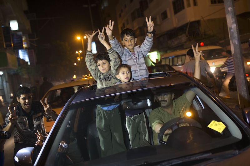 Palestinians celebrate the cease fire agreement between Israel and Hamas in Gaza City, Wednesday, Nov. 21, 2012. Israel and the Hamas militant group agreed to a cease-fire Wednesday to end eight days of the fiercest fighting in nearly four years, promising to halt attacks on each other and ease an Israeli blockade constricting the Gaza Strip. (AP Photo/Bernat Armangue)