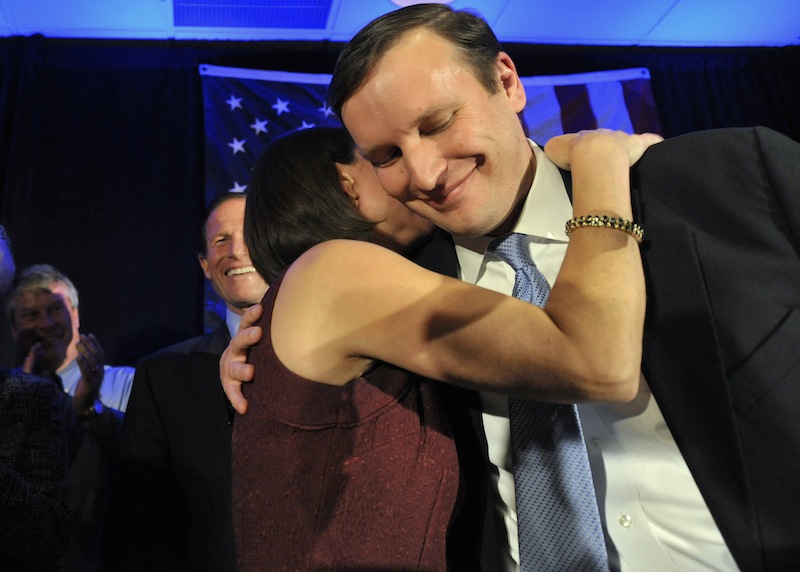 Newley-elected Democratic Sen. Chris Murphy celebrates his win with wife Cathy Holahan Murphy over Republican Linda McMahon in Hartford, Conn., Tuesday, Nov. 6, 2012. (AP Photo/Jessica Hill)