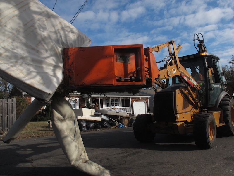 Public works crews in Point Pleasant N.J. remove the ruined contents of homes on Monday, Nov. 5, 2012. A new storm, this one a nor'easter, is expected Wednesday, raising fears of renewed damage along the already hard-hit Jersey shore. (AP Photo/Wayne Parry)