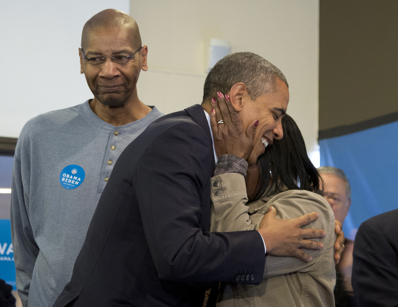 President Obama is embraced by a volunteer as he visits a campaign office in Chicago on Tuesday.