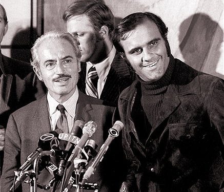 This 1972 photo shows Marvin Miller, left, executive director of the Major League Baseball Players Association, and Joe Torre, of the St. Louis Cardinals, talking to reporters after Miller announced an end to a baseball strike.