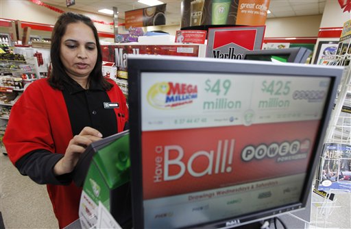 Cashier Farah Husain works a lottery machine for a powerball ticket at a convenience store Tuesday in Richmond, Va.
