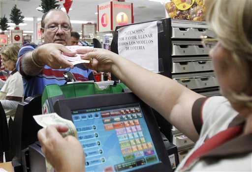 Maria Diaz, right, sells a customer Powerball tickets at a local supermarket in Hialeah, Fla., on Tuesday. There has been no Powerball winner since Oct. 6, and the jackpot already has climbed to more than $500 million, the second-highest jackpot in lottery history, behind only the $656 million Mega Millions prize in March.