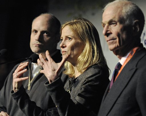 Mary Wittenberg, president of the New York Road Runners, speaks during a news conference Friday, Nov. 2, 2012, in New York, after New York Mayor Michael Bloomberg canceled Sunday's New York City Marathon. At left is Howard Wolfson, deputy mayor for government affairs and communication; at right is George Hirsch, chairman of the board of New York Road Runners. Bloomberg canceled the race after mounting criticism that this was not the time for a race, as the city continues to recover from Superstorm Sandy. (AP Photo/ Louis Lanzano)