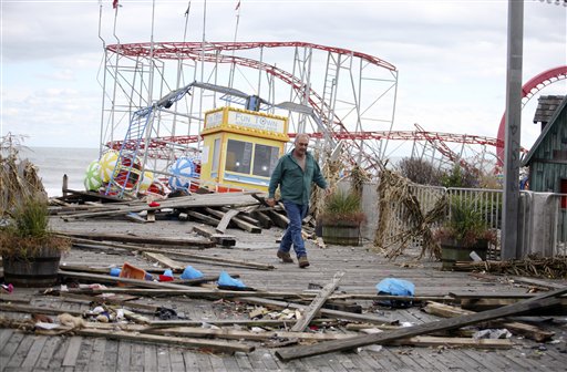 Owner Billy Major surveys the damage to the Fun Town Pier in Seaside Heights on Wednesday. Only four of the rides on the pier survived Sandy.