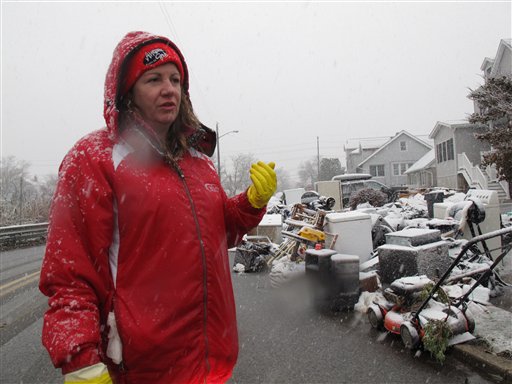 Laura DiPasquale talks about spending a third straight day looking through trash bags holding the contents of her storm-ruined house in Point Pleasant Beach, N.J., on Wednesday.
