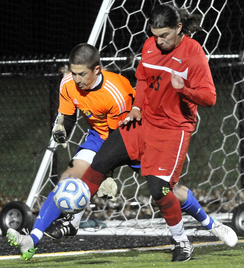 BATTLE IT OUT: Thomas’s Kenny Cano, right, battles for the ball with Maine Maritime Academy goalie William Trace Lacour during the North Atlantic Conference semifinals Wednesday. The Terriers will face Williams College in the first-round of the NCAA Division III tournament Saturday.
