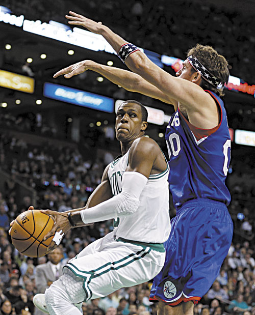 STEP BACK: Boston’s Rajon Rondo, left, makes a move against Philadelphia’s Spencer Hawes during the second quarter of the Celtics 106-100 loss Friday in Boston.