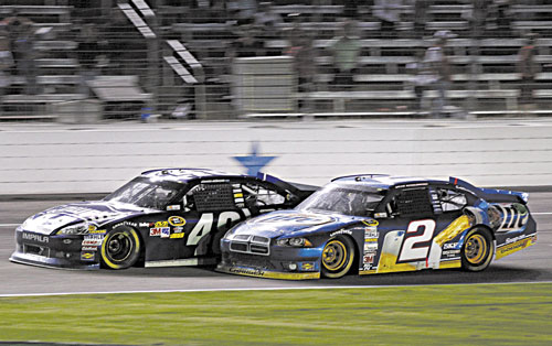 EDGING HIM OUT: Jimmie Johnson (48) and Brad Keselowski (2) bump on the front stretch late in a NASCAR Sprint Cup Series race Sunday at Texas Motor Speedway in Fort Worth, Texas. Johnson won the race.