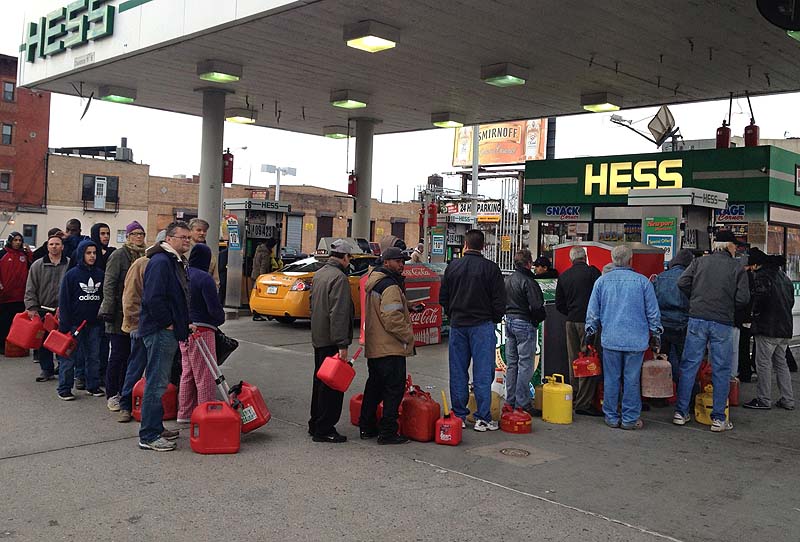 Shortly before the gas ran out, customers wait in line at a Hess station where the line of cars snaked 10 blocks, and at least 60 people waited to fill red gas cans for their generators, in the Gowanus section of Brooklyn.