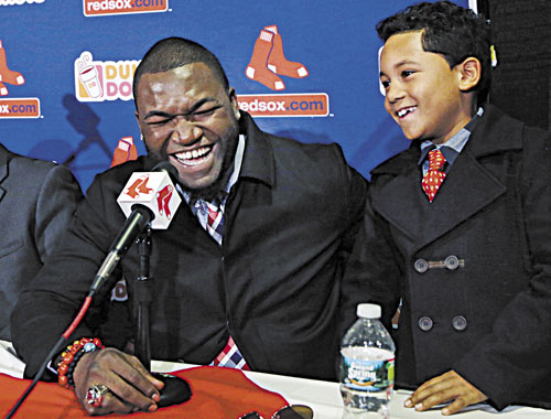 GLAD TO BE HERE: Boston’s David Ortiz laughs with his son D’Angelo, 8, during a news conference Monday at Fenway Park in Boston. Ortiz announced that he has finalized a $26 million, two-year contract, which includes bonuses that could raise the value to $30 million.
