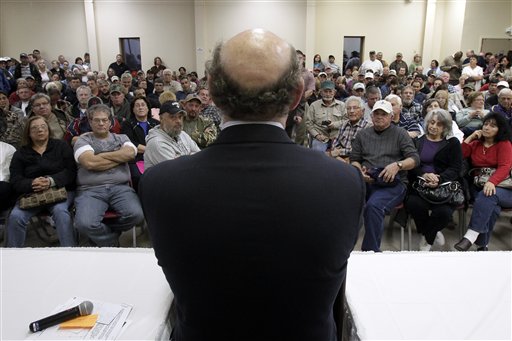 FILE - In this Jan. 10, 2011 photo, claimants listen to BP oil spill fund administrator Kenneth Feinberg, center, as he speaks at a town hall meeting in Grand Isle, La. In court filings late Monday, Oct. 22, 2012, the oil giant BP asked a federal judge to disregard objections from a fraction of claimants and give final approval to a proposed multibillion-dollar settlement for economic damages from the Gulf spill. (AP Photo/Patrick Semansky, File)