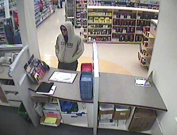 This image from surveillance video shows the robbery suspect at the Rite Aid Pharmacy counter.