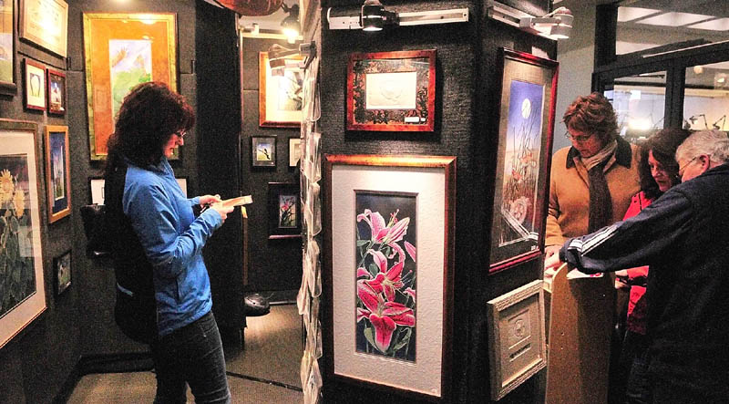 Show-goers look at the Island Designs booth on Saturday afternoon during 16th Annual Crafts at the Museum Show in Augusta. The Maine State Museum is located off of State Street just south of the State House and show continues today from 10 a.m.to 4 p.m.