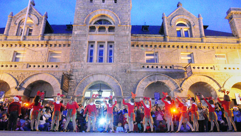 Dancers perform on Water Street, in front of the Olde Federal Building, before the annual tree lighting on Saturday in downtown Augusta.