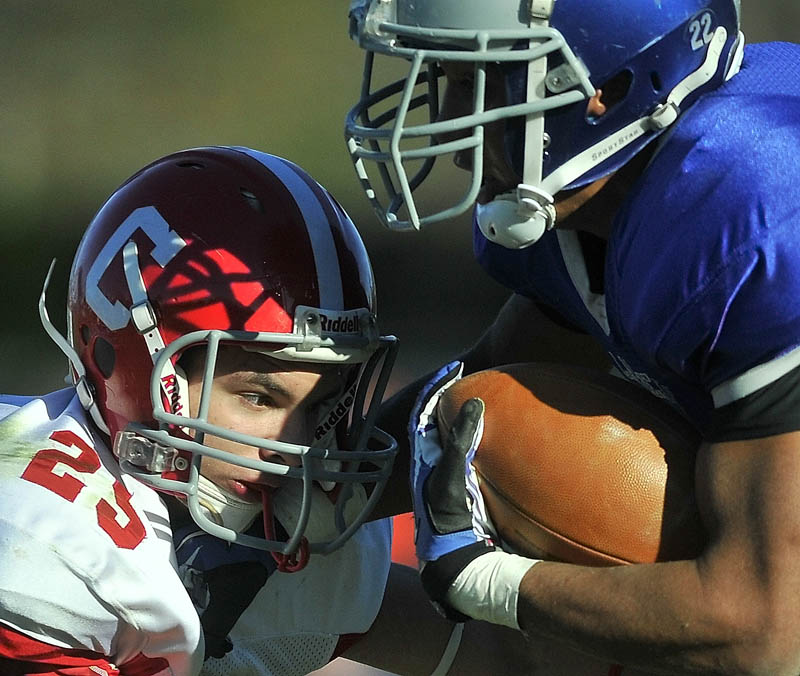 Cony High School's Tayler Carrier, left, gets an eyeful from Lawrence High School's Xavier Lewis Saturday.