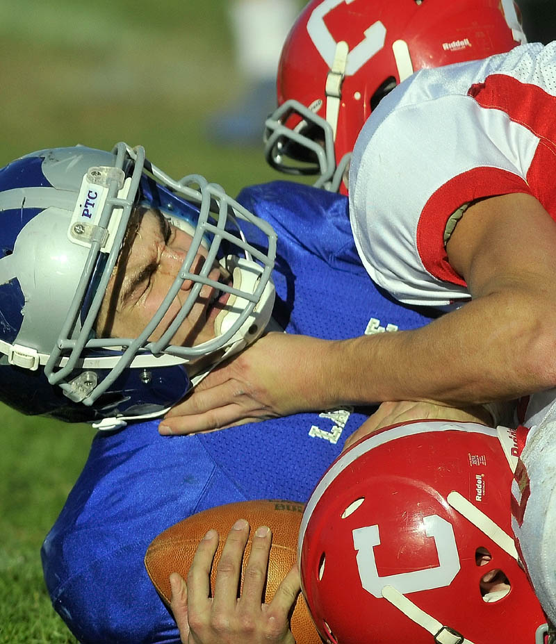 Lawrence High School's Spencer Carey is sacked by Cony High School Saturday.