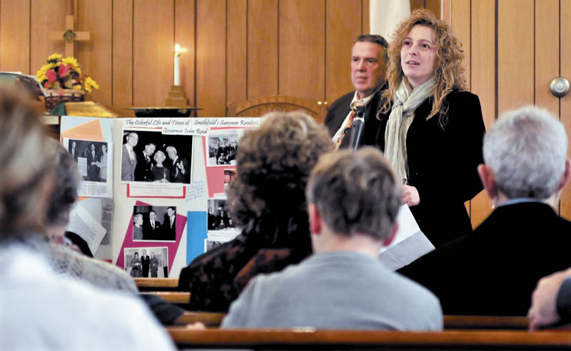 Speaking next to some memorabilia of former Gov. John Reed, Christine Keller fondly recalls him during a celebration of his life at the Smithfield Baptist Church on Sunday. Behind Keller is the Rev. Bert Brewster.