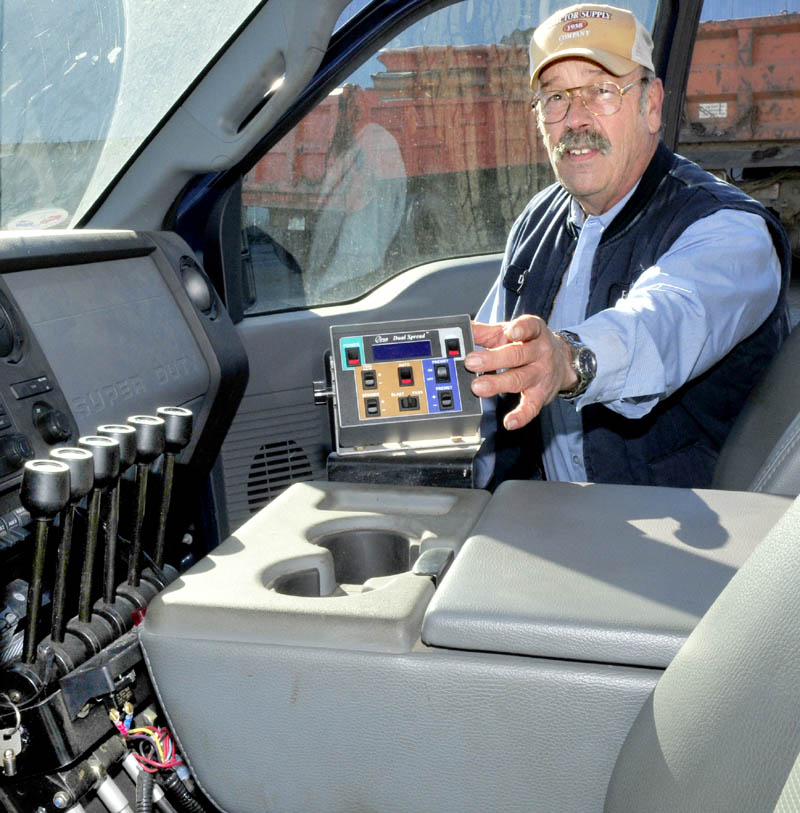 Farmington Director of Public Works Denis Castonguay shows a small computer inside one of the town plow trucks. The equipment can be programed for the most efficient use of salt on winter roads, in terms of both economic and environmental impact.