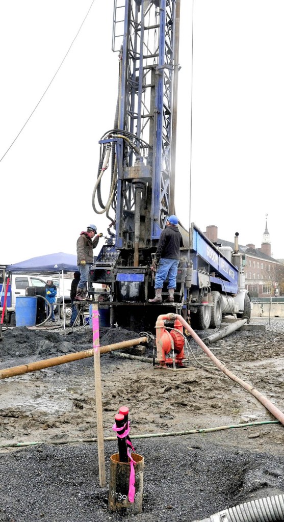 Workers drill geothermal holes on Thursday that will be part of a system to help heat the new science building at Colby College in Waterville.