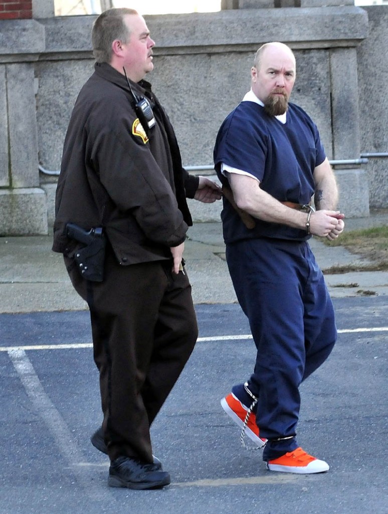 Robert Nelson is led into Somerset County Superior Court in Skowhegan on Monday, for the first day of his trial in the shooting death of Everett L. Cameron.