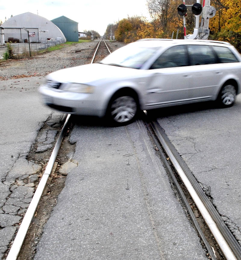 A driver goes over a bumpy Pan Am Railways crossing on Lawrence Avenue in Fairfield on Thursday. The town is working with the Maine Department of Transportation and the railroad to consider repairing the crossings.