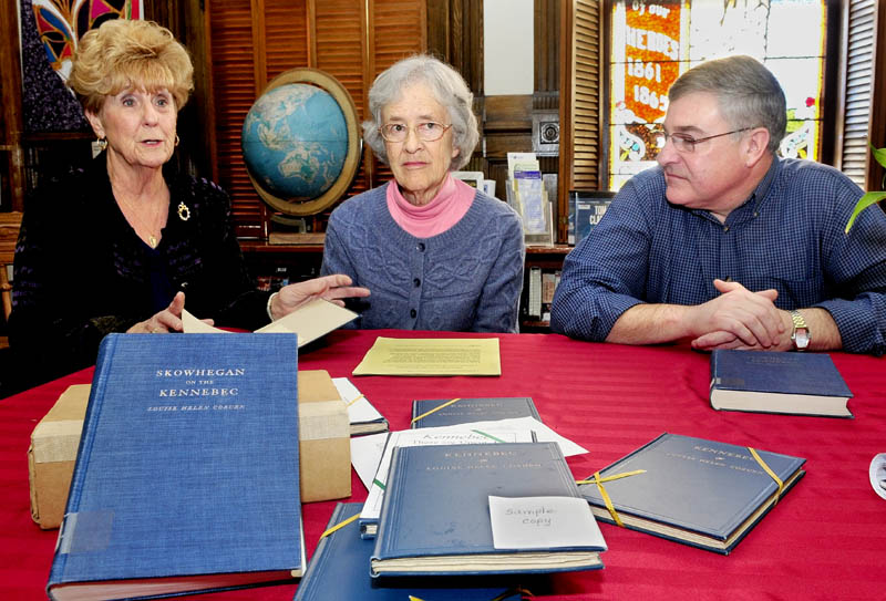 Pat Dickey, left, Corrilla Hastings and Dale Jandreau talk about discovering 170 copies of "Kennebec", written by Louise Helen Coburn, at the Skowhegan Free Public Library, on Monday. The books will be on sale during the Christmas bazaar on Nov. 30 and Dec. 1, and proceeds will go to the library's renovation fund.