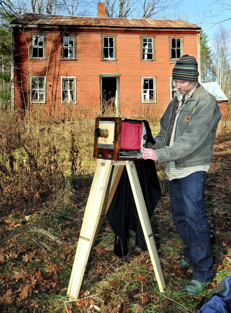 Scott Anton prepares his view camera, which uses glass-plate negatives, to photograph the John Wentworth home in Athens, which was built in 1800. Anton is documenting the old home, as it may be torn down next year.
