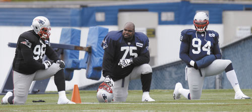 TALKING SHOP: New England Patriots defensive tackle Vince Wilfork (75) talks with defensive end Justin Francis (94) during practice Wednesday at the team’s training facility in Foxborough, Mass.
