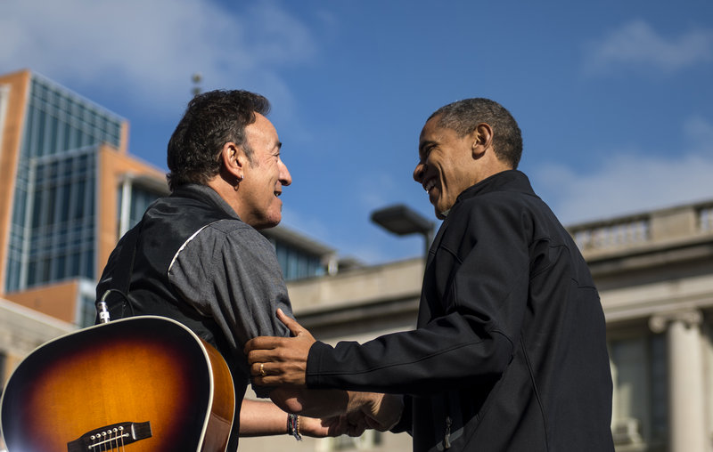 Bruce Springsteen shares a moment with President Barack Obama in Madison, Wis., on Monday. The president urged a crowd of 18,000 supporters to help keep him in the White House.