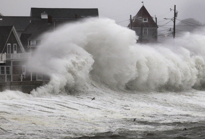 Waves crash into a seawall and buildings along the coast in Hull, Mass., which was feeling the effects of a nor’easter Wednesday, just like New York and New Jersey. A high wind warning was in effect.