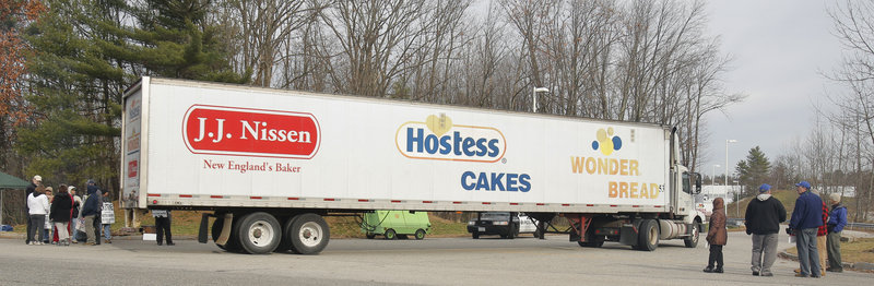 A tractor-trailer enters the Hostess plant in Biddeford, where employees continued to walk a picket line Friday after the company announced it would begin liquidation proceedings. “We still have a trust issue,” said John Jordan, an agent for the bakery’s union. “So we will be out here until we know for sure,” he said.