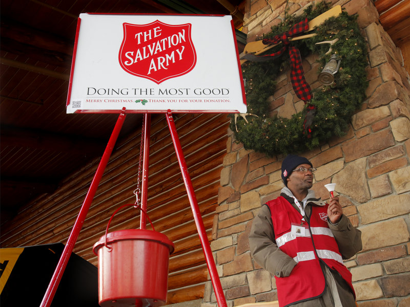 Danny Mitchell rings the bell at a Salvation Army donation kettle at Cabela’s in Scarborough on Wednesday. “This is the time of year when we tell our stories and remind people how life is out there for many of us,” said Maj. Steve Ditmer of the Salvation Army’s Portland Corps.