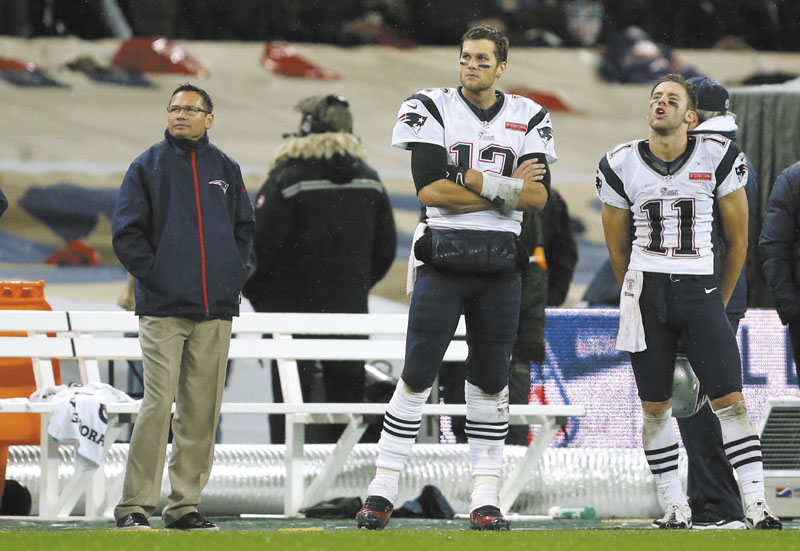 NO MORE WATCHING: New England Patriots wide receiver Julian Edelman, right, and quarterback Tom Brady, watch from the sidlines during the Patriots’ game against the St. Louis Rams on Sunday, Oct. 29 in London. After a bye week, the Patriots return to action Sunday against Buffalo.