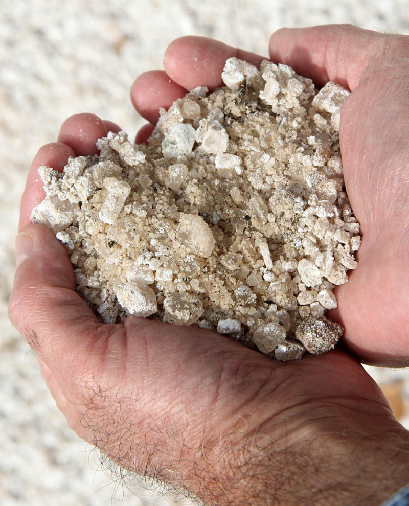 Waterville Public Works Director Mark Turner on Friday holds a handful of salt used on city roads.
