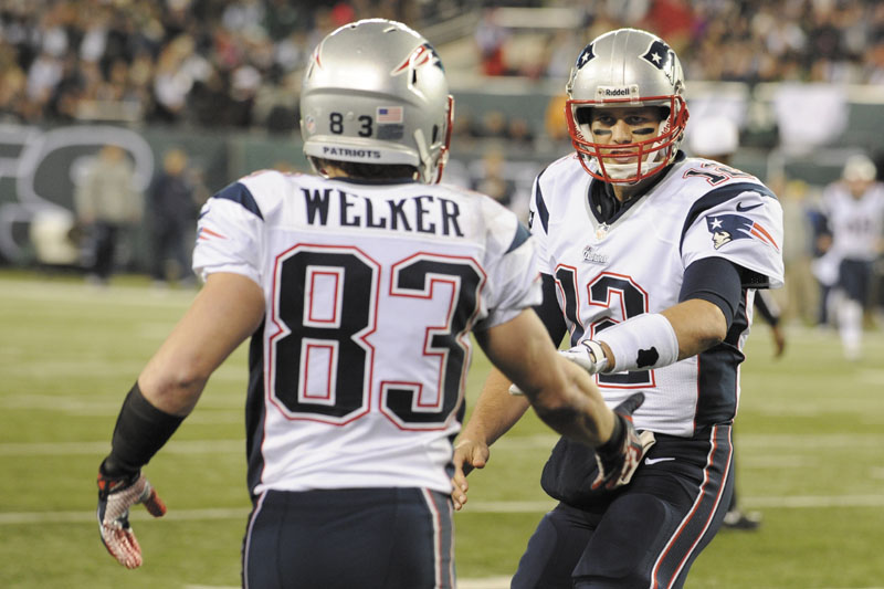 KEEP IT GOING: Wes Welker, left, Tom Brady and the New England Patriots will win their fourth straight AFC East title if they beat the Miami Dolphins on Sunday. New England has won nine division titles in the last 10 seasons.