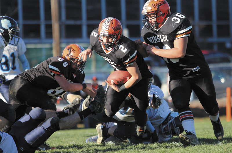 Photo Jeff Pouland LOOKING FOR RUNNING ROOM: Winslow High School's Joseph Hopkins looks upfield for extra yardage after eluding several Dirigo High School defenders during the first half of the Black Raiders' 17-6 victory over the Cougars in the Western Maine Class C final on Saturday.