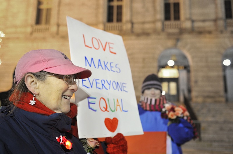Gail Berenson of Portland holds a sign in support of same-sex marriage outside Portland City Hall Friday, December 28, 2012, before the first same sex marriages in Maine were performed. Berenson was part of a group that demonstrated in front of the Cathedral for the past three years.