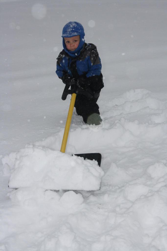 Aiden Wilson, 2 1/2, tries his hand at a time-honored Maine tradition -- shoveling snow -- in Smithfield on Thursday.