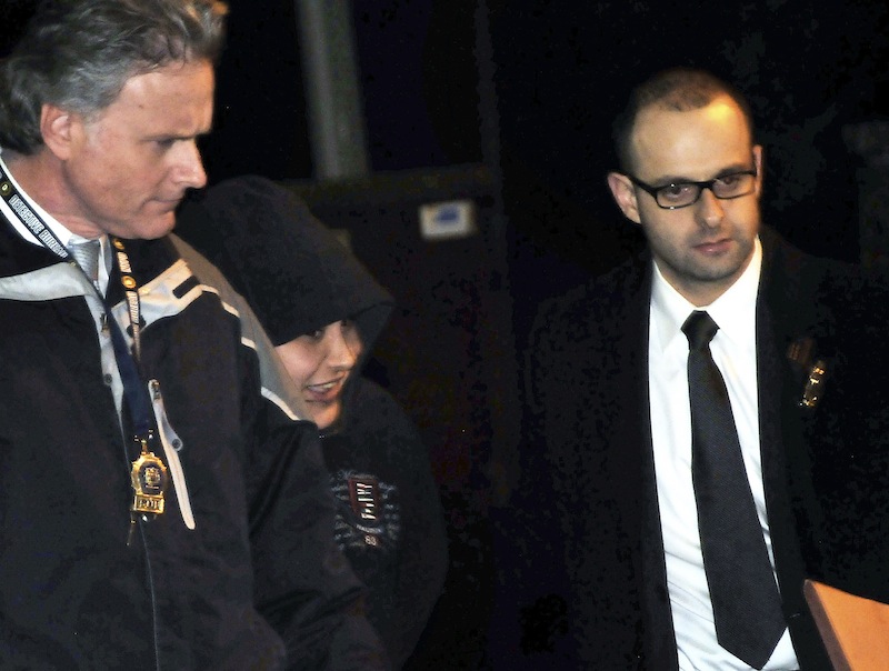 In this Saturday, Dec. 29, 2012 photo, New York City Police Department detectives escort Erika Menendez, second from left, out of the 112th Precinct in the Queens borough of New York. Menendez was arraigned Saturday night on a charge of murder as a hate crime. Judge Gia Morris has ordered that the 31-year-old be held without bail and be given a mental health exam. (AP Photo/Newsday, Danielle Finkelstein)